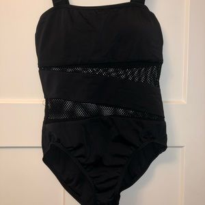Black one piece bathing suit with fishnet styled sections.